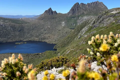 Large mountains covered in plants with a lake in the center