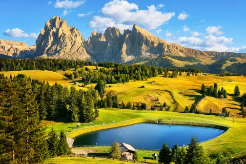 Large grassy valley with a lake in the center