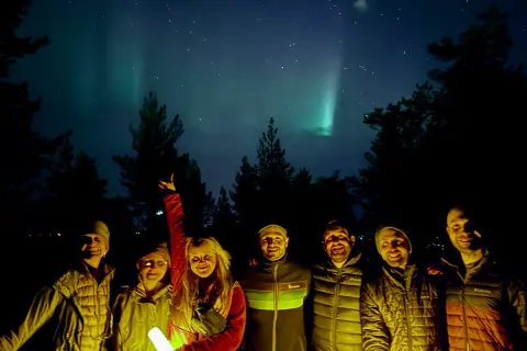 Group of people holding lanterns under the night sky
