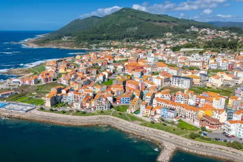 The coastal town of A Guarda in Galicia, Spain, featuring numerous buildings with distinctive orange rooftops.