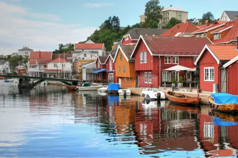 Red buildings and houses along an ocean dock