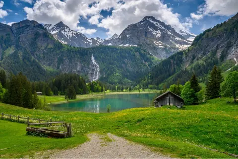 Large valley with a lake in the center, and tall mountains in the distance