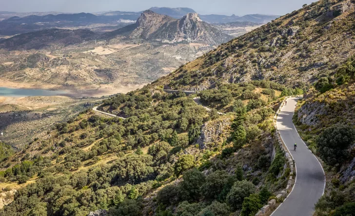 Two Backroads' guests biking on road in mountains, Spain.
