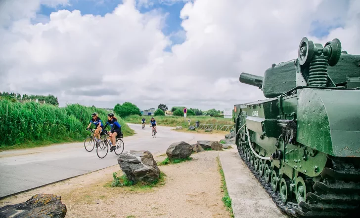 Backroads Guests Biking Past Army Tank