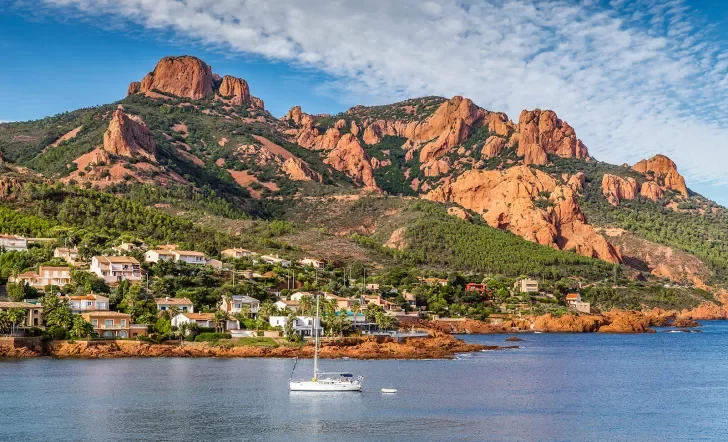 Village And Trees Among Red Rocks of Esterel Massif During Sunny Day-French Riviera, Provence-Alpes, Cote d'Azur, France
