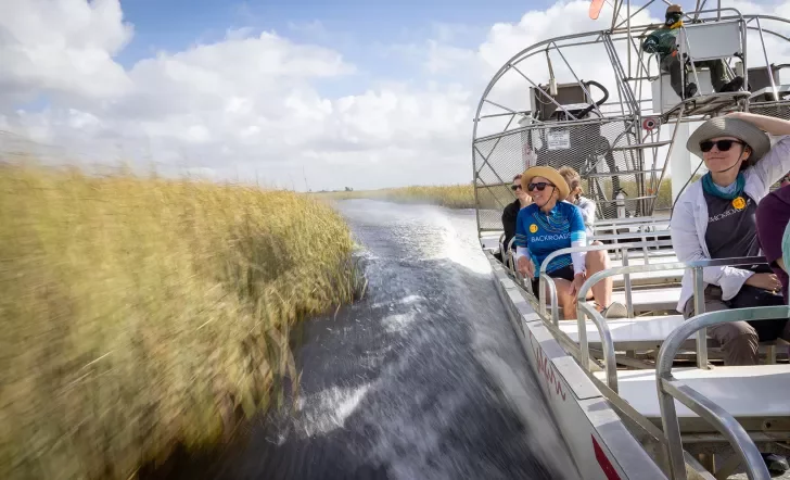 Action shot of guests riding airboat.