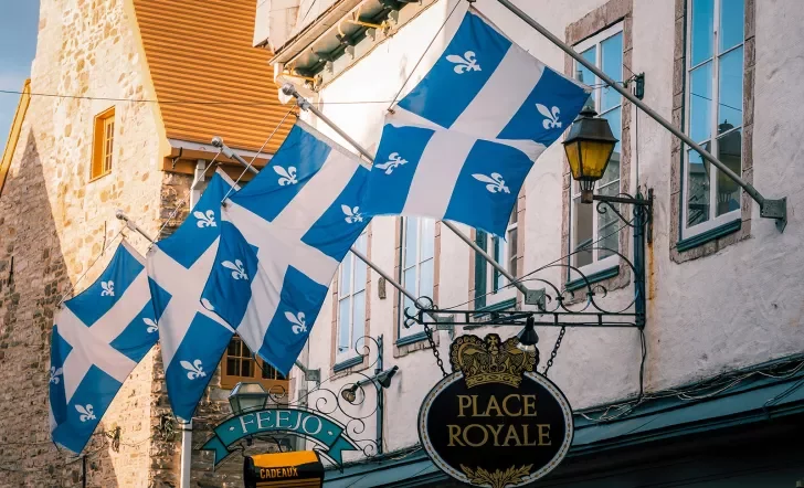Storefront shot of "PLACE ROYALE", Quebec flags proudly displayed.