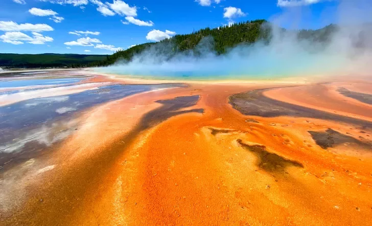 Orange sand leading up to smoking hot springs 