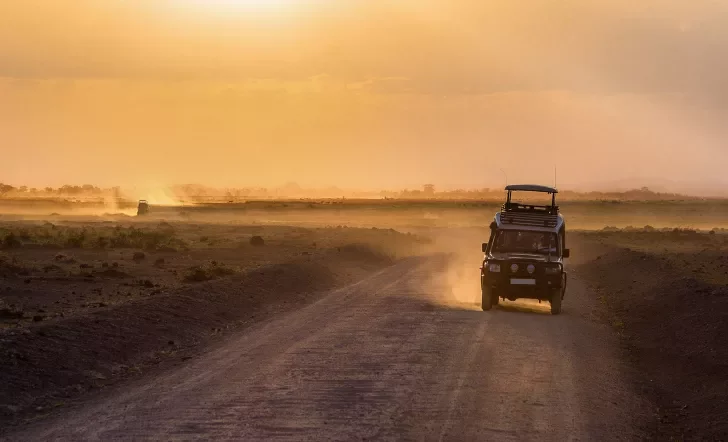 Sunset in african savannah, silhouettes of safari car and animals, Africa, Kenya, Amboseli national park