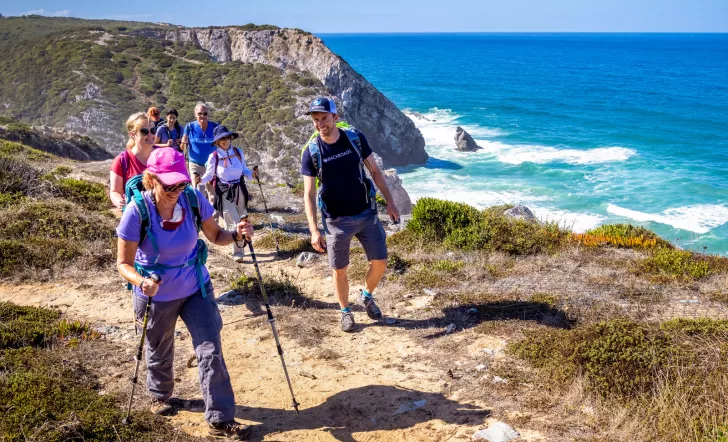 Hikers walking up a shoreline trail