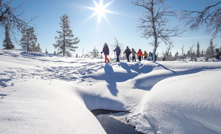 Group of people walking in a valley of snow