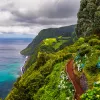 View of flowers on a mountain and the ocean in Miradouro da Ponta do Sossego Nordeste, Sao Miguel, Azores, Portugal. 