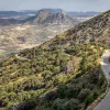 Two Backroads' guests biking on road in mountains, Spain.
