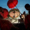 novice monks beating a new dry with palm reeds and splashing water
