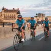 Three guests cycling in French town, Château Royal d'Amboise in background.