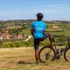 Rear shot of guest with bike, looking towards vineyard town.