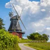Windmill with dramatic clouds hovering over
