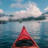 POV shot of guest kayaking, large lake, other guests, clouds etc.