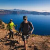Two guests hiking along the rim of Crater Lake.
