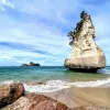 Tall rock formation by the beach in New Zealand