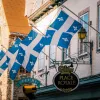 Storefront shot of "PLACE ROYALE", Quebec flags proudly displayed.
