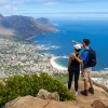 Couple standing on an overlook above a coastal town