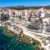 Wide shot of Corsican coastline. Houses dotting the hillside.