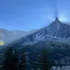 Shot of large mountain eclipsing sun, camera is in shadow.