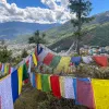 Brightly colored flags strung up above a valley in Bhutan
