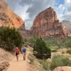 Hikers walking on trail in canyon