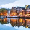 Houses lit up along a canal