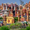 Bikers cycling through red and yellow temples