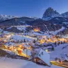 A small town covered in snow and lit up with lights