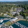 Sky view of a property complex with boats along a port 