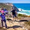 Hikers walking up a shoreline trail