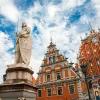 Latvian attraction - house of the Blackheads, sculpture of Saint Roland and Saint Peters Church in old city Riga, Latvia