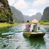 Group of people on a raft, paddling in the middle of a river