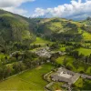 Sky view of a large valley with trees and small houses