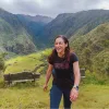Woman smiling while ascending on a grassy hill