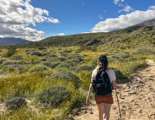 A woman hiking on a dirt path