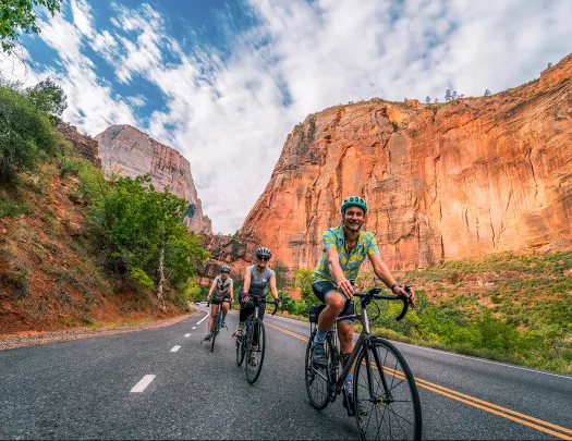 Below eye-level shot of three bikers in canyon