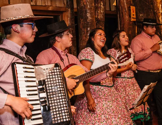 Band playing accordion, guitar and tambourine. 