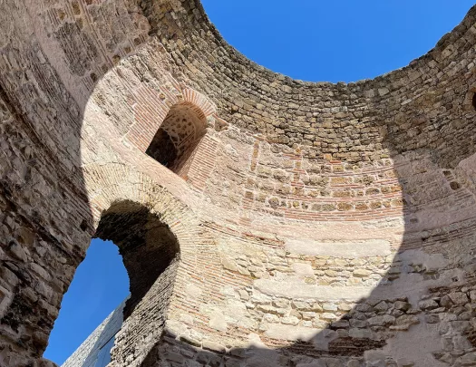 Ground shot of inside of circular brick and stone building.