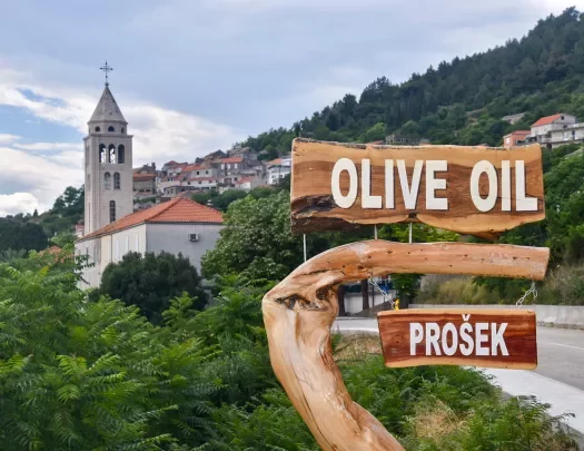 Shot of Croatian hillside town, Prosek, and 'Olive Oil" sign.
