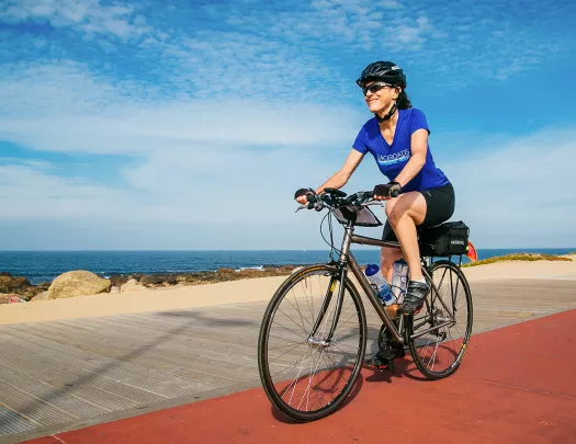 Biker riding on a road along the Douro River.