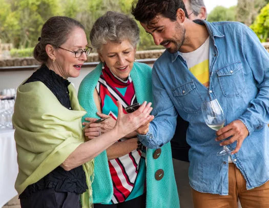 Three guests looking a phone.