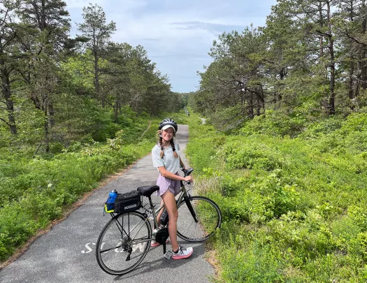 Young guest on small backroad with bike.