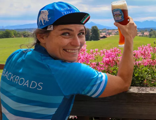 Backroads leader posing with pint of beer.