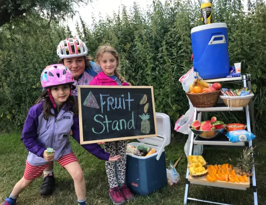 Kids posing at fruit stand snack table