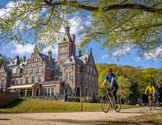 guests biking past beautiful building